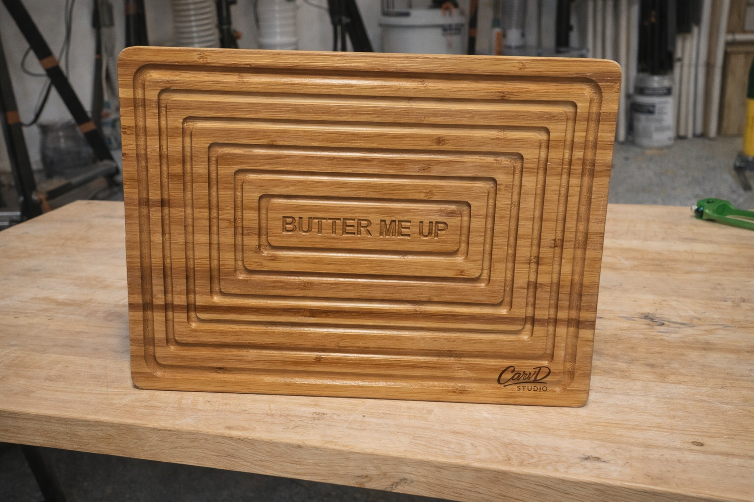 Bamboo cutting board with 'Butter Me Up' engraving on a wooden surface