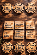Wooden coasters with humorous sayings on a wooden surface